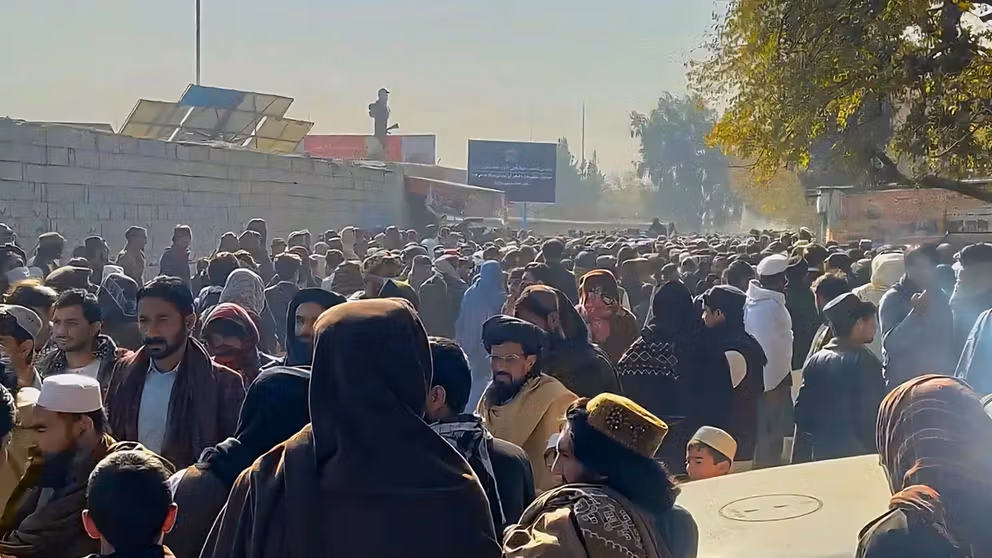 A large crowd fills Khost stadium as Taliban officials conduct a public execution.